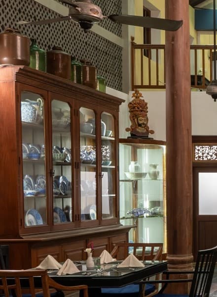 Antique cabinet with blue-and-white porcelain and a gilded Buddha statue