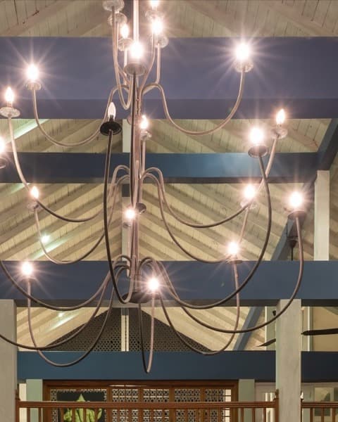 Wrought-iron candle chandelier beneath the vaulted roof