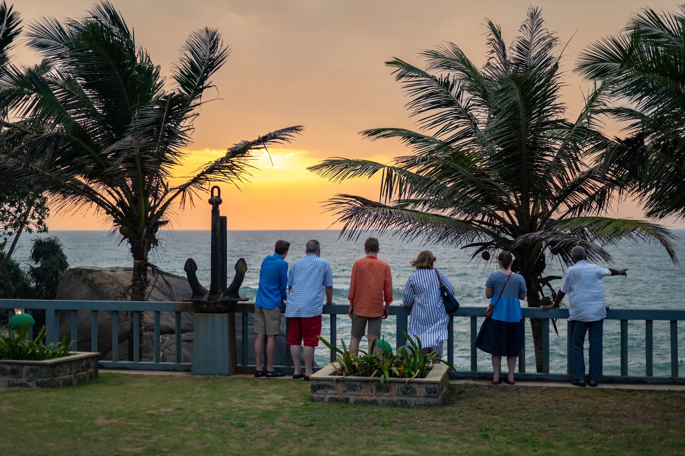 Guests watching the sunset over the ocean
