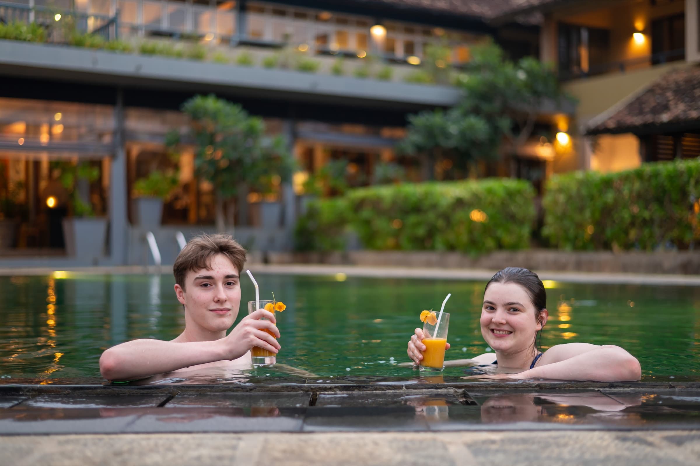 Guests relaxing in the pool with drinks