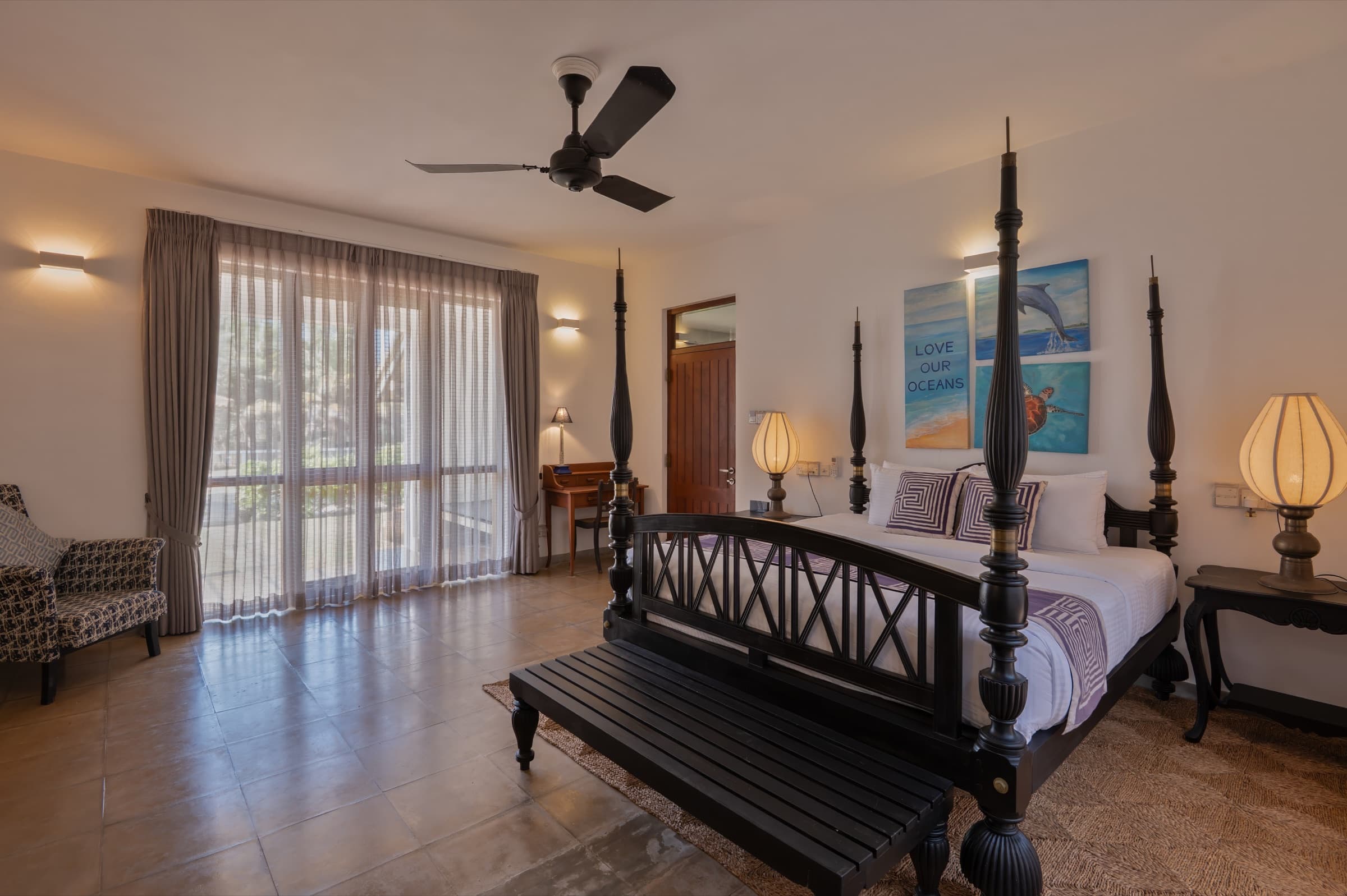 Guest room with dark wood four-poster bed