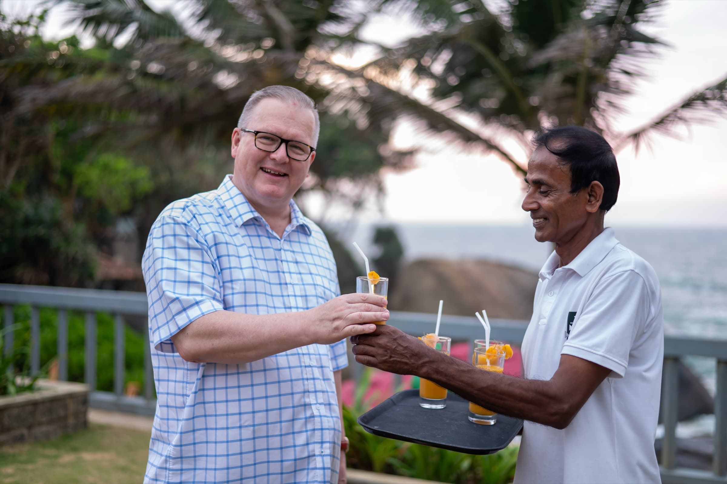 Staff serving drinks with an ocean view