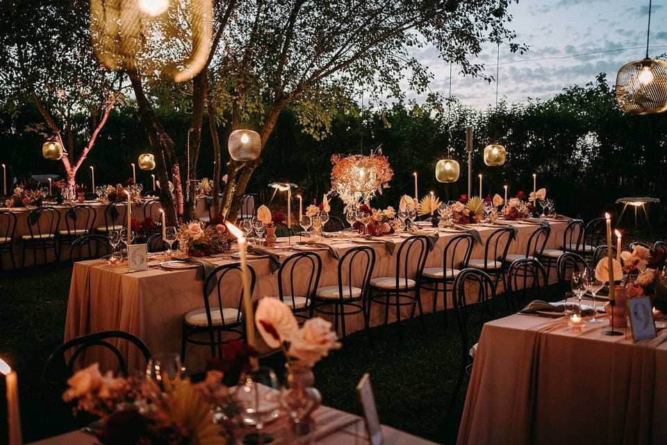 Long table garden dinner setting under string lights