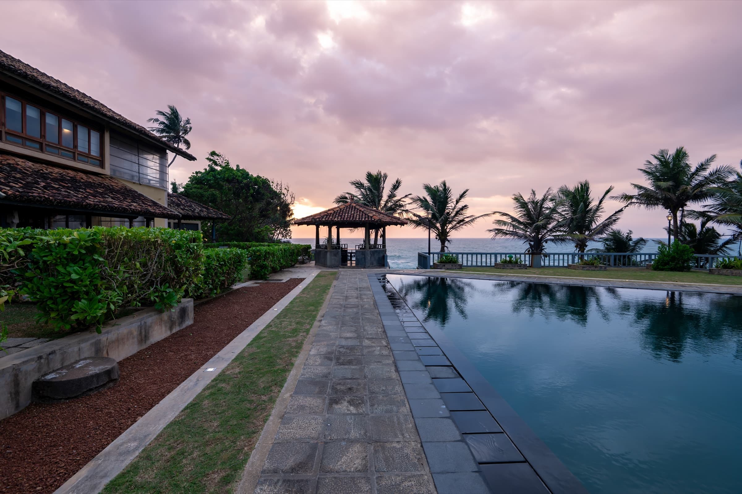 Garden pathway beside the pool at dusk
