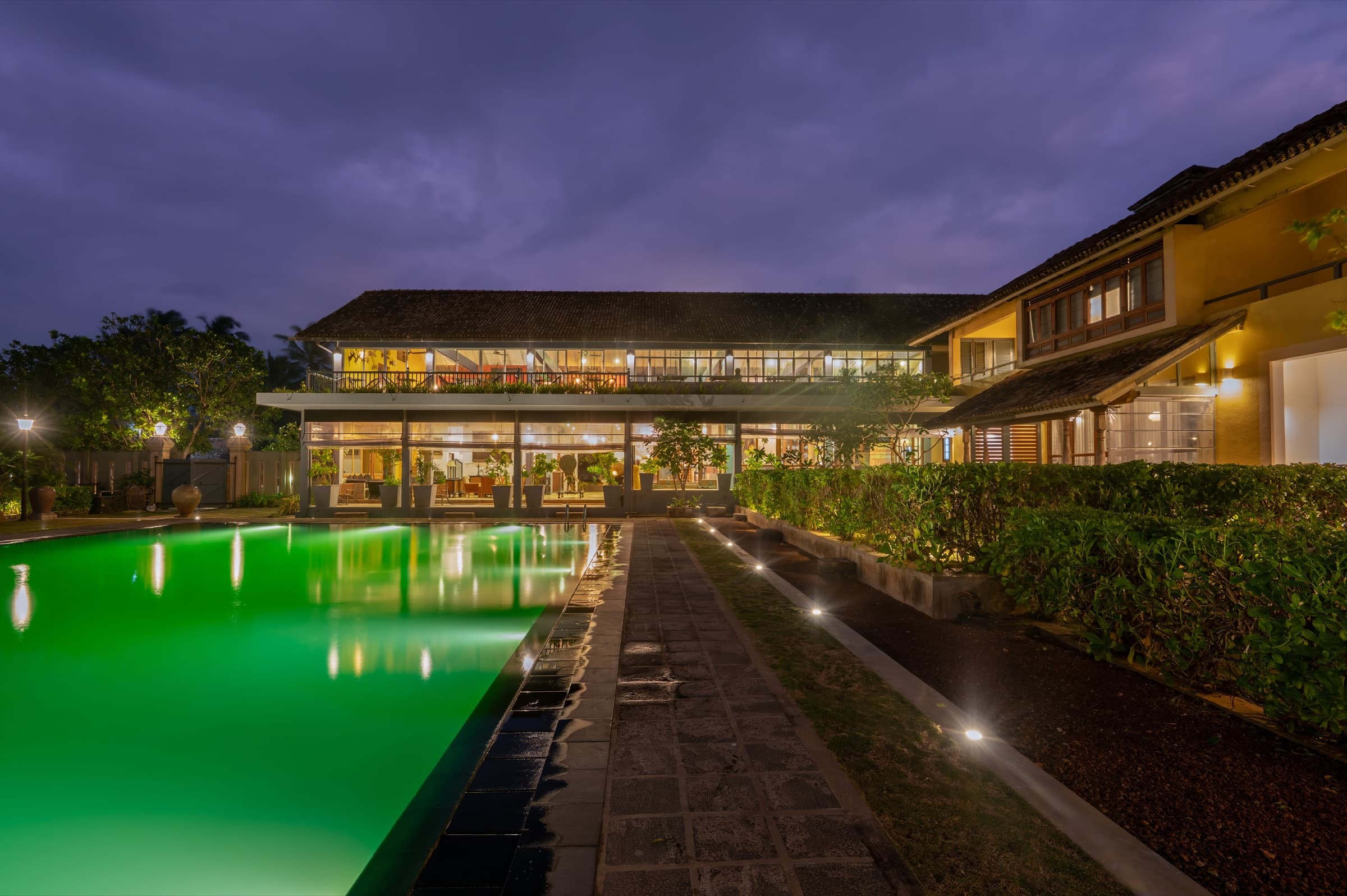 Two Anchor property and pool under a purple dusk sky
