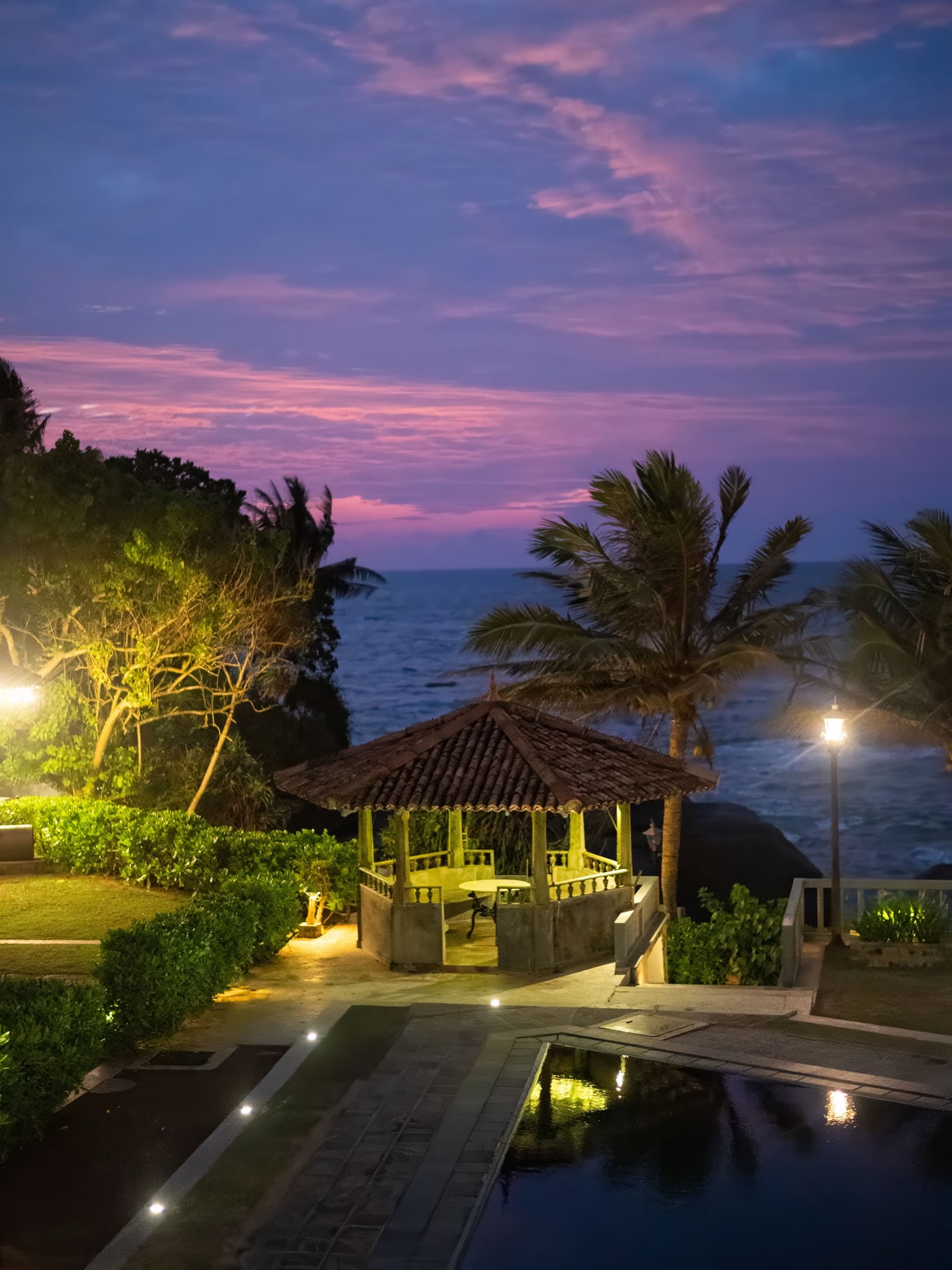 Garden gazebo by the pool at dusk